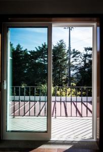 a sliding glass door with a view of a balcony at Hostel Encostas Do Douro in Marco de Canaveses