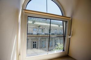a window with a view of a building at Guest House "Arkhistratyg" in Lviv