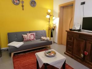 a living room with a couch and a table at Villa Alessandra in Colle Isarco