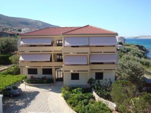 a building with solar panels on its roof at Rooms Villa Andreja in Pag