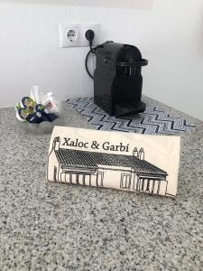 a box sitting on top of a counter with a stove at Garbí & Xaloc apartamentos in Cala Galdana