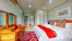 a bedroom with a bed and a dresser and a desk at San Lameer Supreme by Top Destination Rentals in Southbroom +49 photos