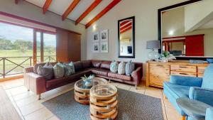 a living room with a couch and a table at San Lameer Supreme by Top Destination Rentals in Southbroom