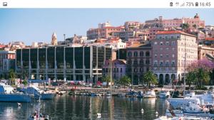 a city with boats in a harbor with buildings at SAILING in Cagliari