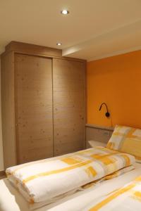 a bedroom with a bed with a large wooden cabinet at Pedrin's House in Livigno +4 photos
