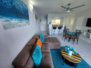 a living room with a couch and a table at Contemporary Ocean view 2bed Carib Ocho Rios Condo in Ocho Rios
