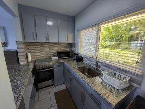 a kitchen with a sink and a counter top at Contemporary Ocean view 2bed Carib Ocho Rios Condo in Ocho Rios