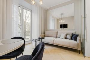 a living room with a couch and a table and chairs at Bob W Tallinn City Centre - Ambassador in Tallinn