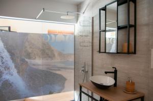 a bathroom with a sink and a mirror at Las Mareas de Llanes in Andrín