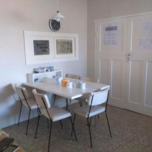 a dining room with a white table and chairs at Weltevreden Guest Farm in Klavervlei