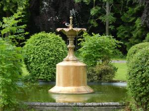 a statue of a water fountain in a park at Mansfield Castle Hotel in Tain