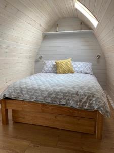 a bedroom with a bed in a small room at Slades farm Glamping in Westbury