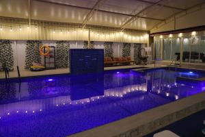 a large swimming pool with purple lights on it at Aljood Resort in Ras al Khaimah