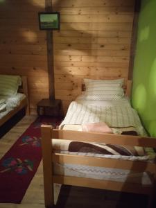 a bedroom with a bed in a wooden room at Holiday Home Vila Milka in Kremna