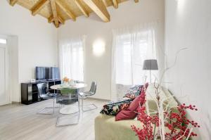 a living room with a couch and a table at Gelsomini appartamenti sul lago dOrta in Orta San Giulio