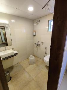 a bathroom with a toilet and a sink at Airport Regency in Devanhalli