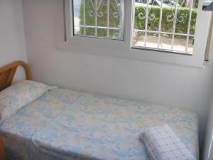 uma cama num quarto com uma janela em Allotjament Joana em Riumar