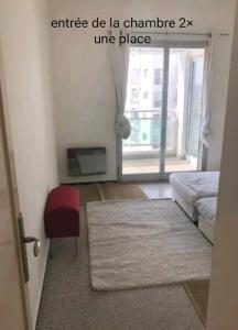 - un salon avec un lit et une chaise rouge dans l'établissement Appartement RIM, à Casablanca