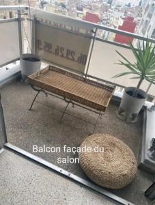 a bench sitting on top of a balcony at Appartement RIM in Casablanca +21 photos