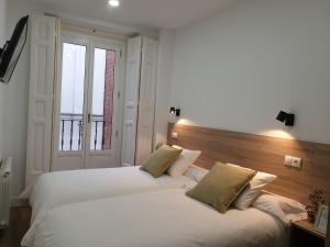 Postel nebo postele na pokoji v ubytování Norte Oviedo Rooms Madrid