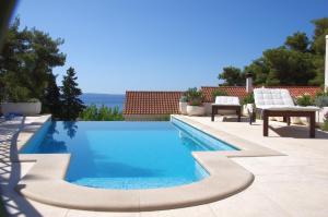 a swimming pool in the middle of a house at Holiday Home Nevista in Sumartin