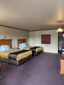 a hotel room with two beds and a tv at Amber's Inn and Suites in Wisconsin Dells +101 photos