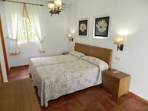 a bedroom with a bed in a room with a window at Hostal Las Acacias in Los Caños de Meca