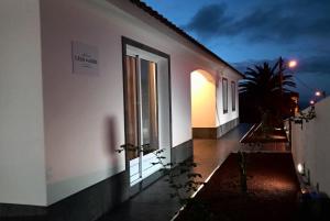 a building with a lit up window at night at CASA DO ADRO -GRANEL in Nordeste