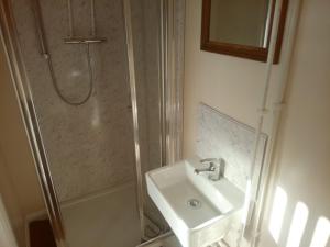 a bathroom with a sink and a shower at Market Place guest house in Burslem