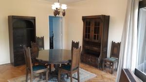 a dining room with a glass table and chairs at Maadi International Center Apartments in Cairo