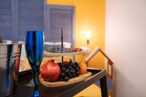 a tray of fruit on a table with a candle at Titmouse Hotel in Moscow