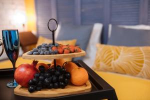 a tray of fruit on a table in a room at Titmouse Hotel in Moscow