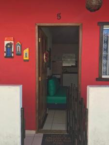 drzwi do pokoju z czerwoną ścianą w obiekcie Casa quadra praia Jacaraipe w mieście Serra