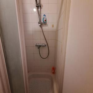a bathroom with a shower with a tub at Sleep and Enjoy in Brussels