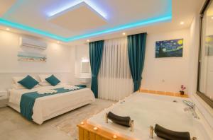 a bedroom with a bed and a bath tub at MULBERRY SUİT APART in Kaş