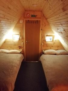 a small room with two beds in a cabin at Brvnara Orfej in Gornje Pale +17 photos