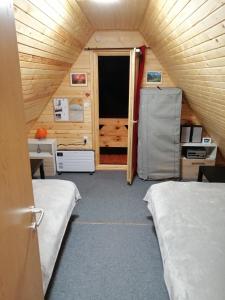 a small room with two beds and a door at Brvnara Orfej in Gornje Pale +17 photos