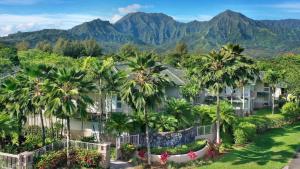 an aerial view of a resort with palm trees and mountains at Villas of Kamali'i Mountain Waterfall Views in Princeville