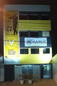 a building with signs on the side of it at Hotel Kairos in Campina Grande