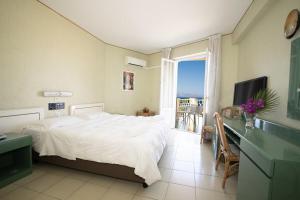 a bedroom with a bed and a desk and a window at Perla Del Golfo Resort in Terrasini