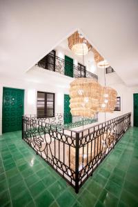 a room with a staircase and green flooring at William Hotel Boutique De Diseño in Taxco de Alarcón +110 photos