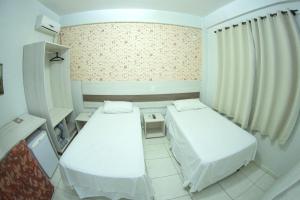 Postelja oz. postelje v sobi nastanitve Hotel Sambakia