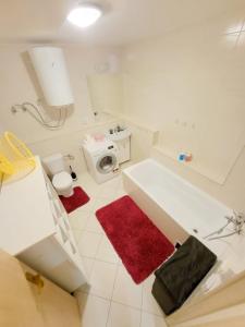 a white bathroom with a sink and a toilet at Veľký apartmán 2 in Karlova Ves