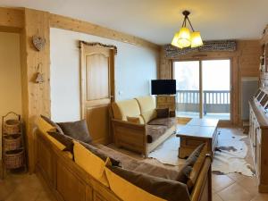 a living room with a couch and a tv at Appartement Villard-sur-Doron, 4 pièces, 8 personnes - FR-1-293-363 in Villard-sur-Doron