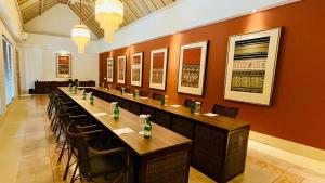 a long row of tables and chairs in a restaurant at Sudamala Resort, Komodo, Labuan Bajo in Labuan Bajo