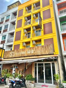 un edificio amarillo con una motocicleta estacionada frente a él en Cat Story Hotel, en Patong Beach