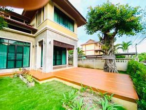 a wooden deck in front of a house at Preme House Boutique in San Sai