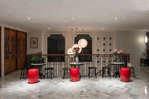 a room with tables and chairs and a balcony at The Lantern Hatyai Hotel in Hat Yai