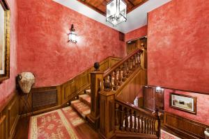 a hallway with a staircase and red walls at Elba Palace Golf Boutique Hotel - Adults Only in Caleta De Fuste