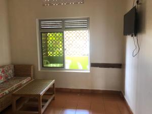 a living room with a couch and a window at Suba Motel in Kihihi